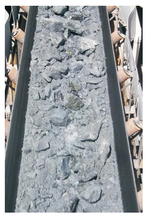 FIG 4 - View of muck on a conveyor.
